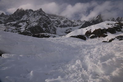 Scenic view of snow covered mountains against sky