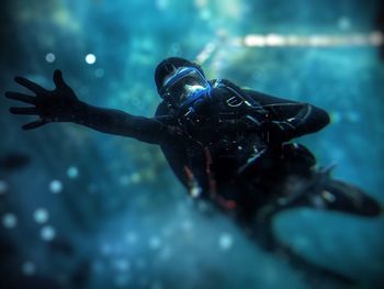 Low angle view of man scuba diving in turquoise sea