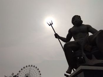 Low angle view of man playing basketball against sky