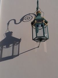 Low angle view of lantern hanging on street light