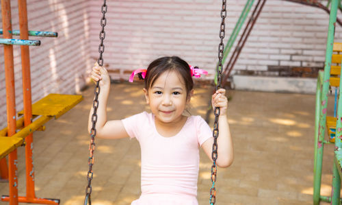 Portrait of smiling girl holding while standing outdoors