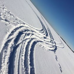 Aerial view of snow covered landscape against sky