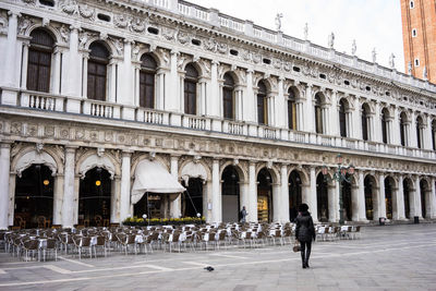 People walking in front of historical building