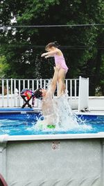 Young woman jumping in park