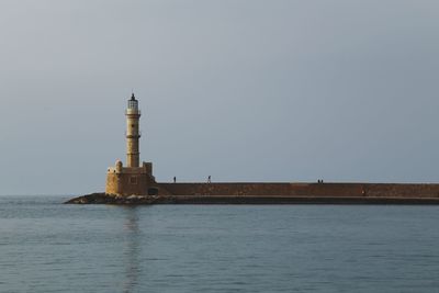 Lighthouse on building by sea