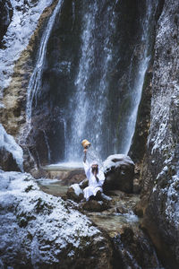 Full length of man standing on rock formation