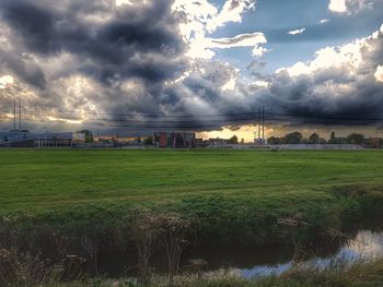View of fields against cloudy sky