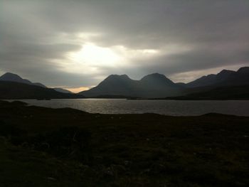 Scenic view of lake and mountains against sky