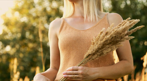 Midsection of woman standing outdoors