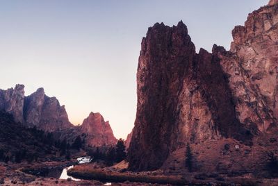 Rock formations on landscape against sky