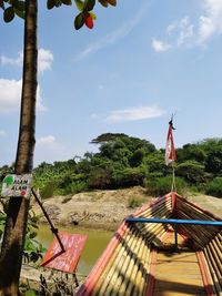 Built structure against trees and plants against sky