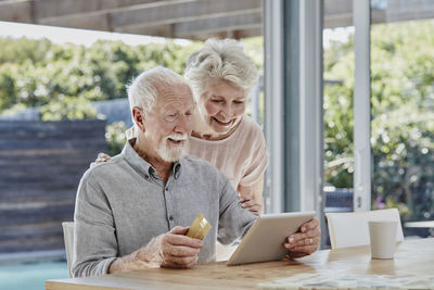 Senior couple doing online payment with credit card