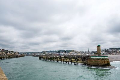 Scenic view of sea by buildings against sky