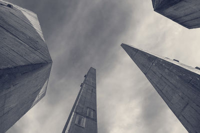 Low angle view of buildings against cloudy sky