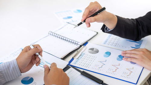 Cropped image of man using laptop on table