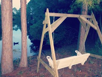 Built structure on field against trees in forest