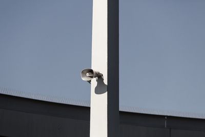 Low angle view of electric lamp against clear sky