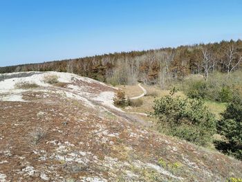 Scenic view of land against clear blue sky