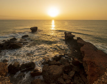 Scenic view of sea against sky during sunset