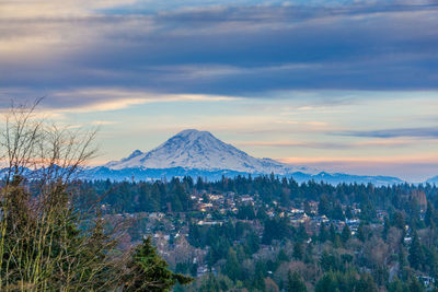 A view of mount rainier with clouds above.