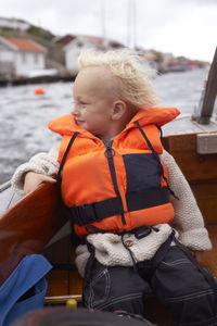 Boy in life vest on boat