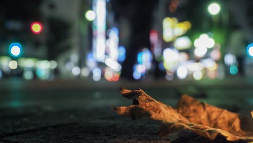 Close-up of illuminated city street at night