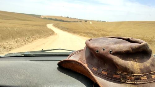 Close-up of car on road against landscape