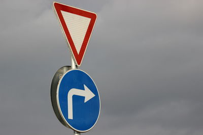 Low angle view of information sign against sky