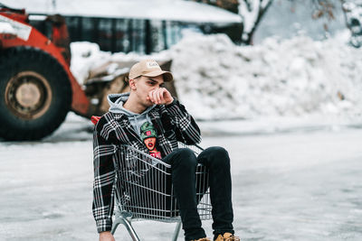 Full length of senior woman sitting in winter