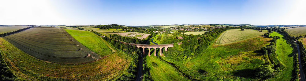 Panoramic view of agricultural field against sky