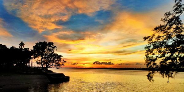 Scenic view of lake against orange sky