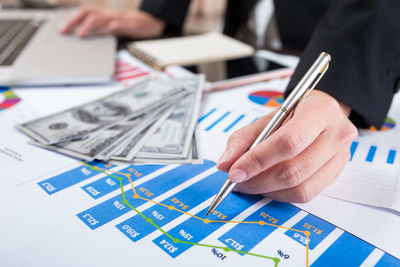 Midsection of business person working over documents at office