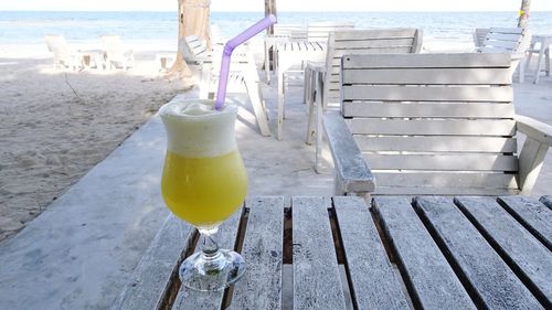 Close-up of drink on table at beach