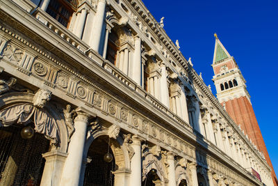 Low angle view of historic building against blue sky