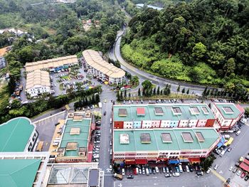 Aerial view of vehicles on road against buildings