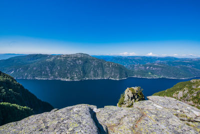 Scenic view of mountains against blue sky