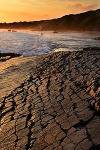 Scenic view of beach against sky during sunset