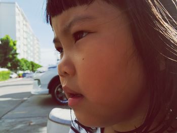 Close-up of cute girl looking away