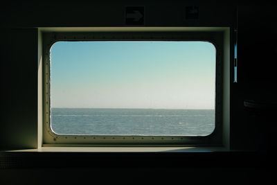 View through a boat window on to the sea