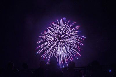 Low angle view of firework display at night