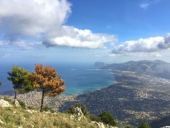 Scenic view of sea and mountains against sky