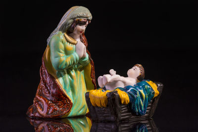 Statues showing birth of jesus christ against black background