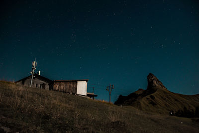 Low angle view of buildings against sky at night