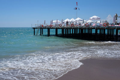 Pier on sea against clear sky