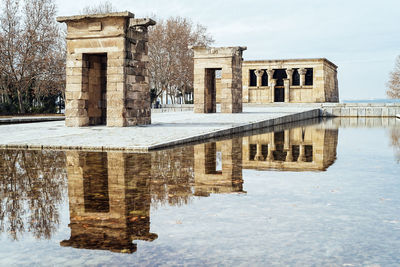 Reflection of old built structures in pond