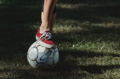 Low section of person with ball on field