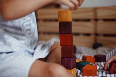 Midsection of man playing with toy blocks