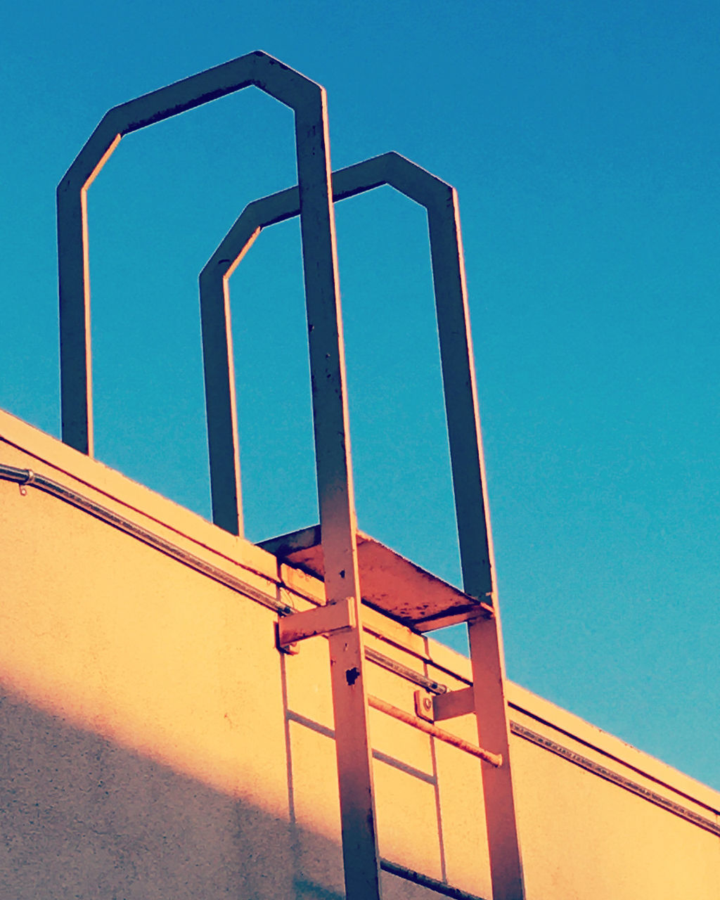LOW ANGLE VIEW OF LADDER AGAINST SKY