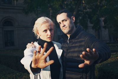 Portrait of young couple standing outdoors