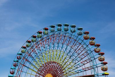 Low angle view of ferris wheel against sky